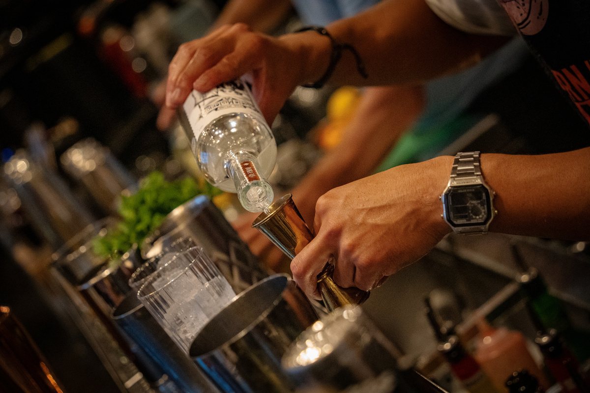 Close-up of a precise pour into a mixing tin