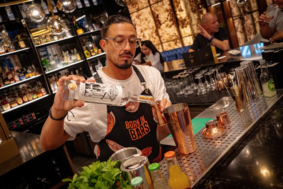 Guest bartender shaking a copper tin