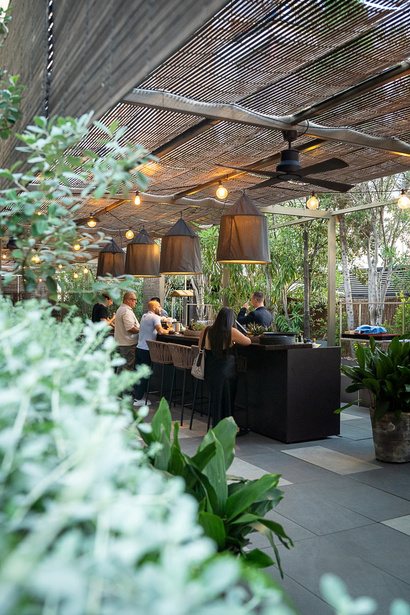 Leafy terrace bar under woven shade