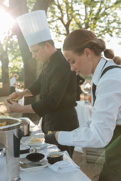 Chefs plating at an outdoor catering station
