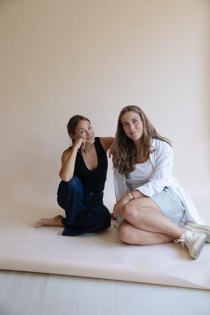 Bianca and Annette, founders of Cayma Agency, sitting together in their studio