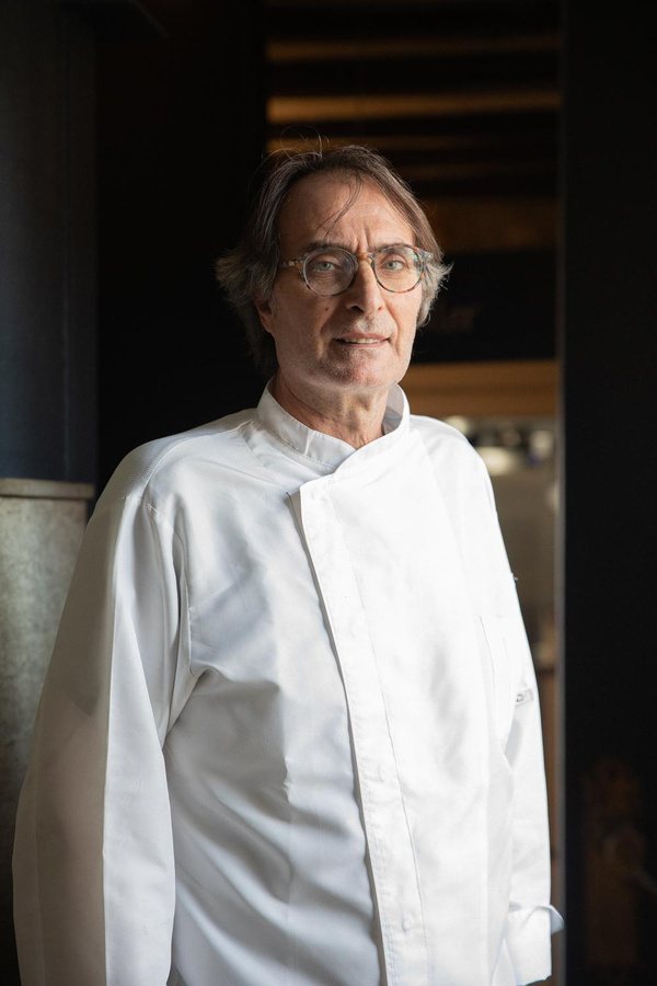Portrait of a chef in whites at the restaurant door