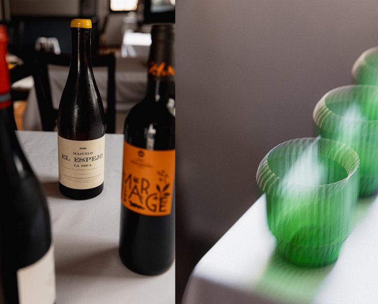 Natural wines and green glasses on white linen
