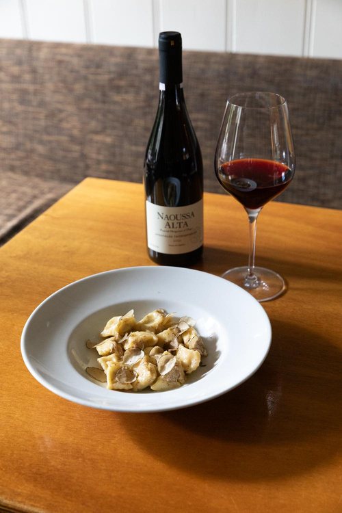 Truffle ravioli with a bottle of Naoussa red