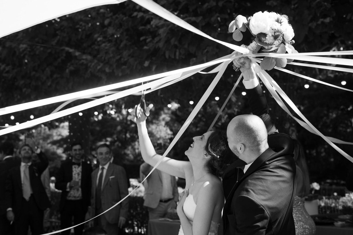 Couple under a maypole of white ribbons